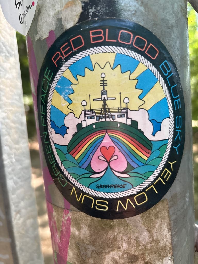 Red blood blue sky Yellow Sun Green peace sticker in Oosterbeek